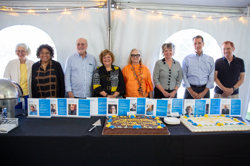 Eight retiring faculty members pose together.