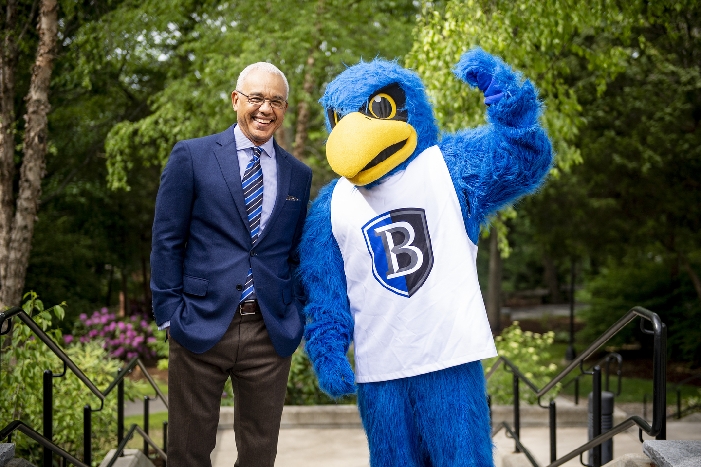 President Chrite poses with Flex the Falcon.