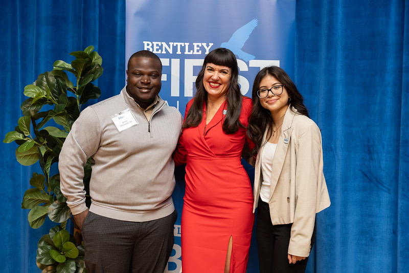 Jane DeLeon Griffin, associate provost for student success, poses with two students after a pinning ceremony for Bentley students who are the first in their families to attend college.