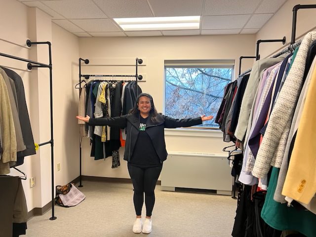 Person standing in Bentley career closet with clothing racks