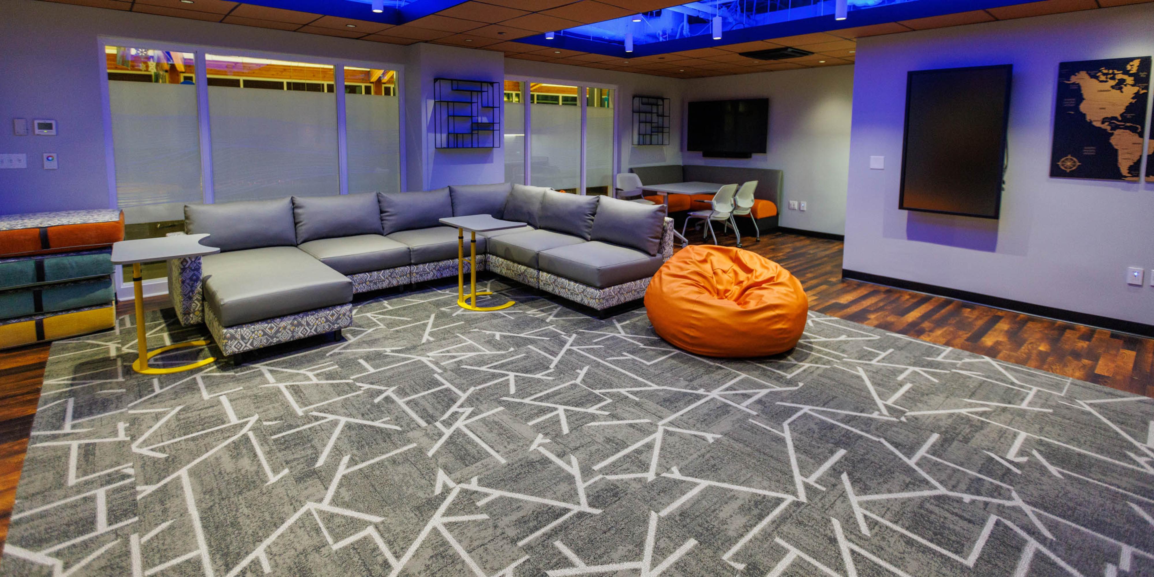 Bentley Multicultural Center after renovations with sectional couch and orange bean bag chair
