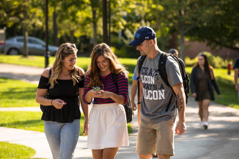 three students walk on campus