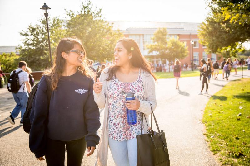 two students walk together on campus