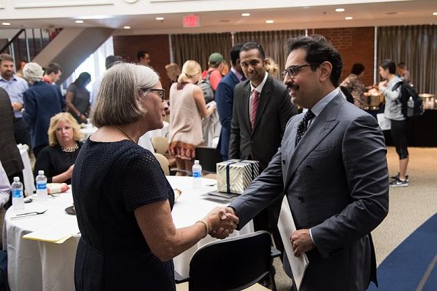 The ambassador on campus shaking hands with a person