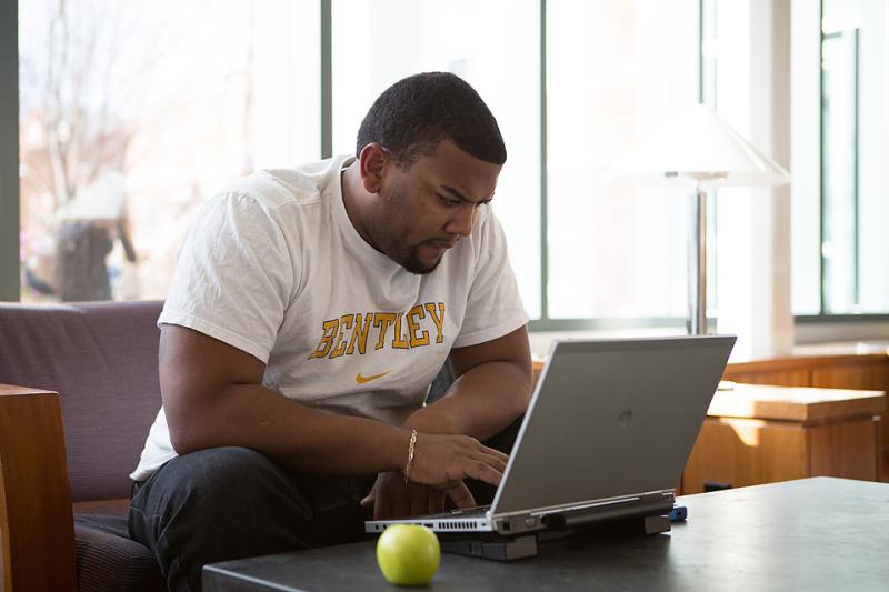 Black male student on laptop