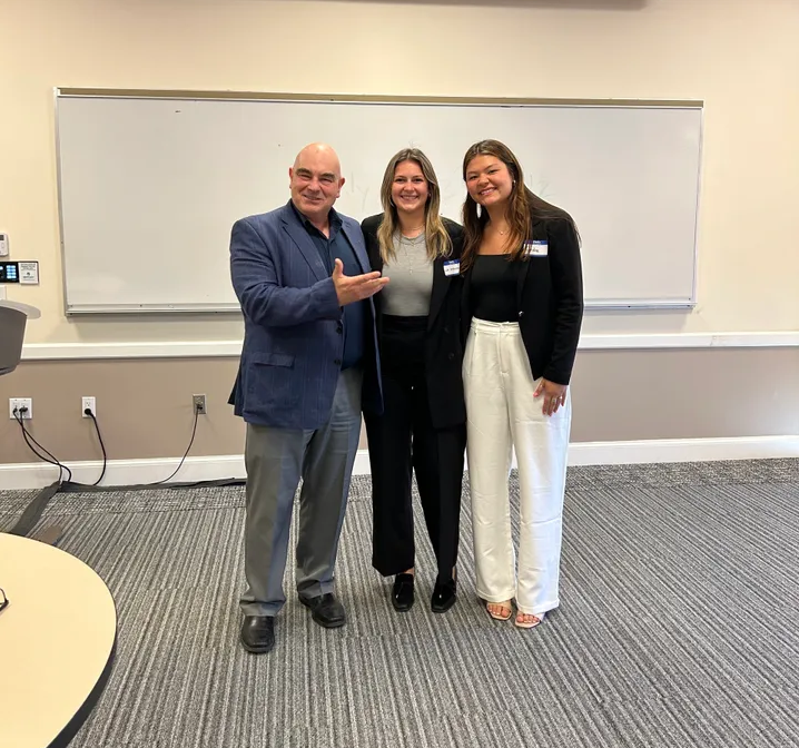 Professor Pouli with students at the sales competition