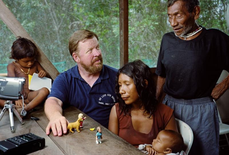 Dan Everett talks with a Pirahã man, his wife and their children: a young boy and an infant.